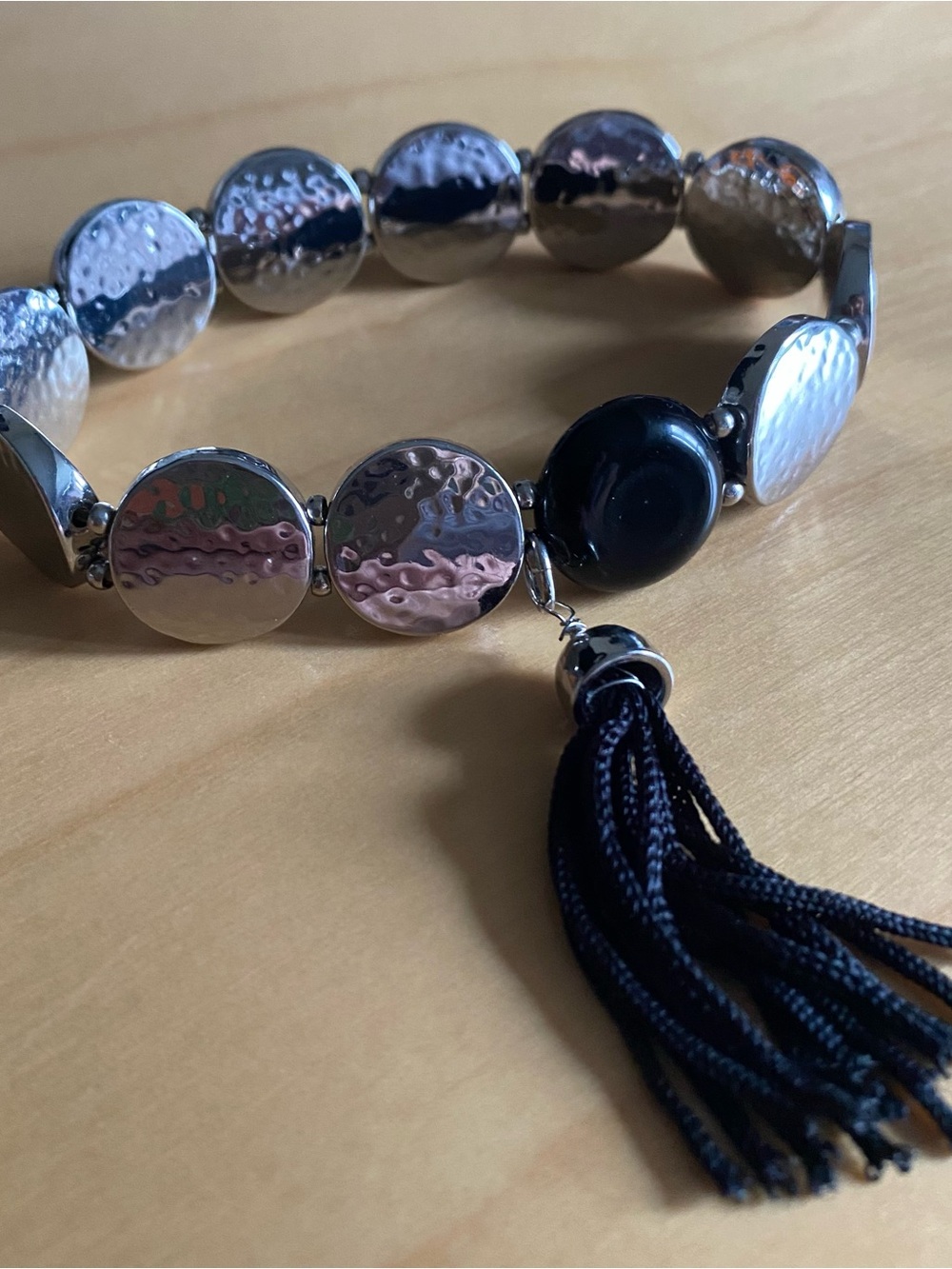 Silver toned elastic beaded tassel bracelet